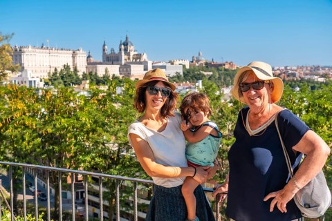 A family with child visiting the Cathedral of Santa Maria la Real de la Almudena and Royal Palace