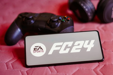 In this photo illustration, the EA SPORTS FC 24 logo is displayed on a smartphone screen, next to a