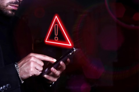 Hacker control and spying on your mobile phone. Symbol of caution in the use of cell phones.