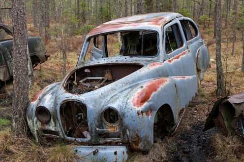 Old car wreck in the car cemetery of Kyrkoe Mosse, Ryd, Tingsryd, Kronoberg County, Sweden, Europe