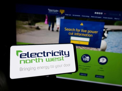 Stuttgart, Germany, 10-28-2023: Person holding mobile phone with logo of British energy company