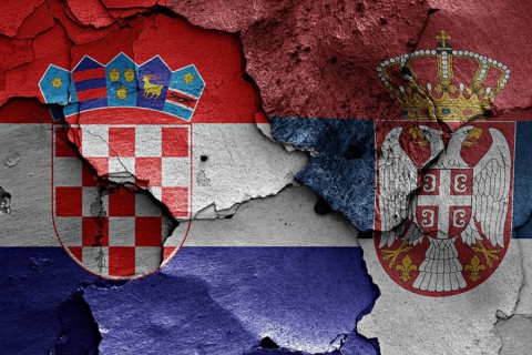 Flags of Croatia and Serbia painted on cracked wall