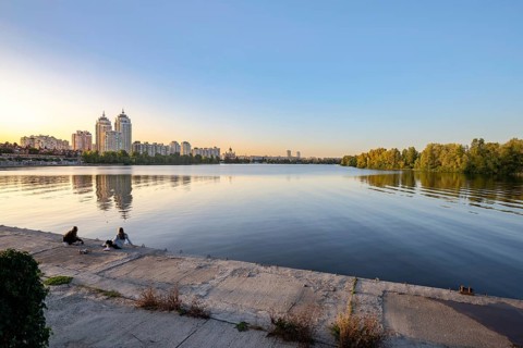 Ukraine, September 22, 2020, Two girls on the embankment close to the high Obolon buildings near