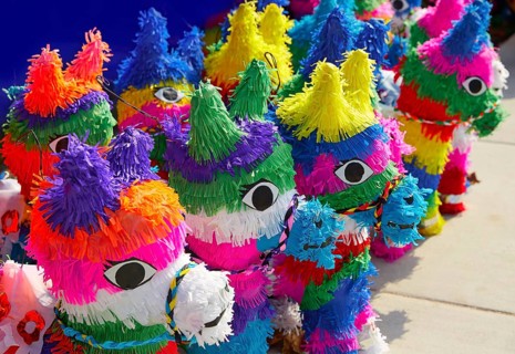 Mexican party pinatas decorated with fringed tissue colorful paper