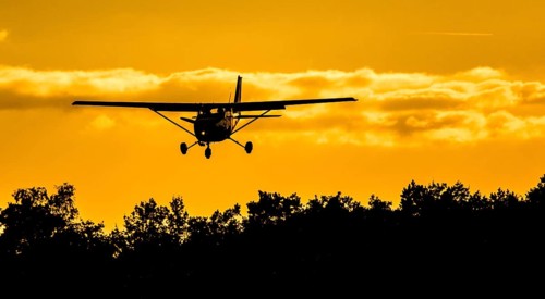 Cessna 172 approaching in the sunset