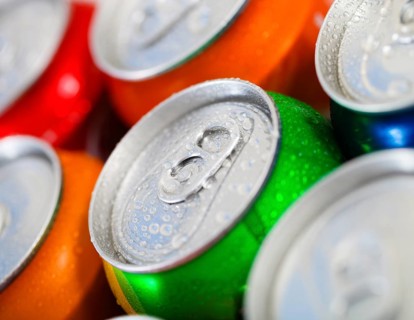 Cans of sweet drinks (or beer) . Cooling frozen and with water drops