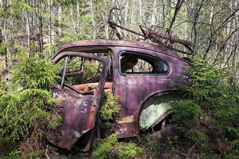 Old car wreck in the car cemetery of Kyrkoe Mosse, Ryd, Tingsryd, Kronoberg County, Sweden, Europe
