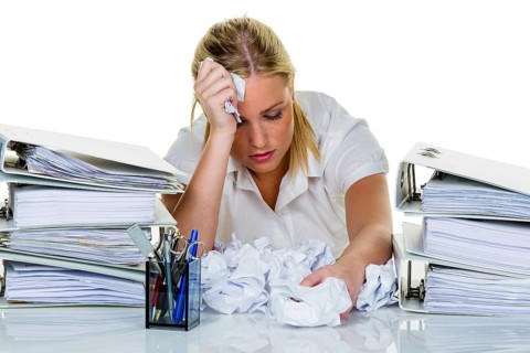 Young woman in the office is overwhelmed with work. burnout syndrome at work or study. Austria