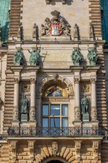 Detail facade Hamburg City Hall with city coat of arms, windows, sculptures and rich decorations on