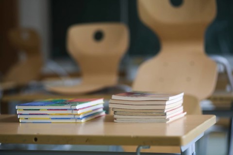 School furniture with textbooks in an empty classroom. Bavaria, Germany, Europe