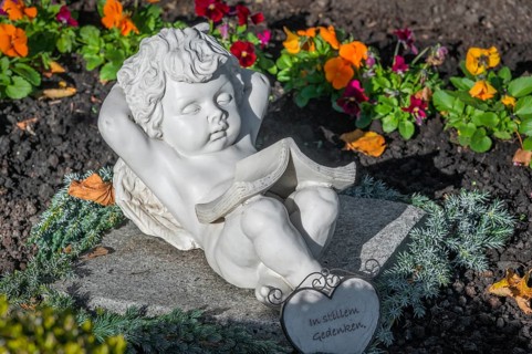 Grave with sleeping cherub near the rococo church of St Ulrich, affectionately known as -the little
