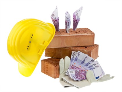 Symbolic photo house building, financing, building savings. Brick and euro, hard hat, craftsman,