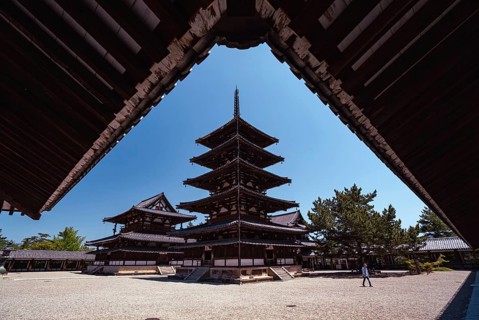 A man walks in front of the five-storey pagoda of the Horyuji Buddhist temple in Nara. The temple