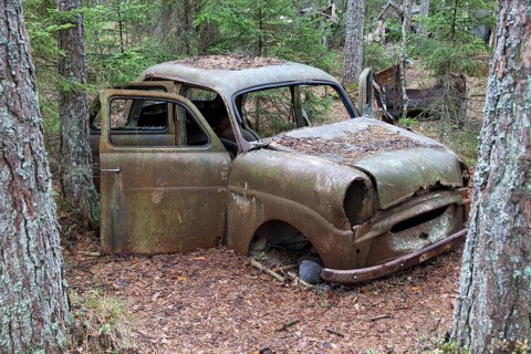 Old car wreck in the car cemetery of Kyrkoe Mosse, Ryd, Tingsryd, Kronoberg County, Sweden, Europe