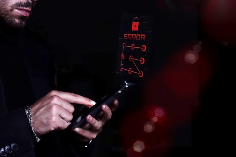 A man in a dark suit troubleshooting a system error on his digital tablet.