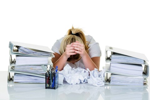 Young woman in the office is overwhelmed with work. burnout syndrome at work or study. Austria