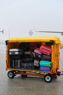 Baggage with baggage tag with control tower during thunderstorm, heavy rain, rain cloud, storm,
