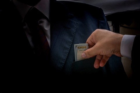 Concept for corruption and bribing fraud finance with Bundle of dollar