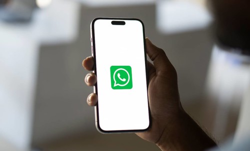 Man holding a cellphone with WhatsApp on the screen.Dhaka, Bangladesh- 09 September 2024.
