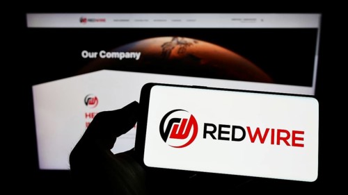 Stuttgart, Germany, 09-04-2022: Person holding mobile phone with logo of American aerospace company