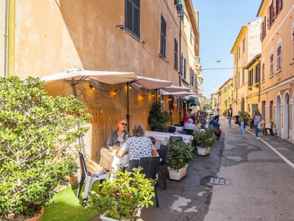 Guests at the tables in front of the restaurants in Via Roma, Orbetello, Tuscany