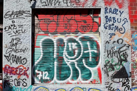 Colourful graffiti on a shutter of a window, Bremen, Germany, Europe
