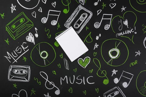 Spiral blank notepad blackboard with drawn musical notes cassette tapes compact discs. Resolution