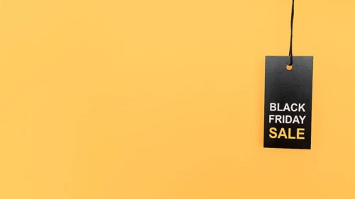 Hanging red black friday sale label copy space yellow background