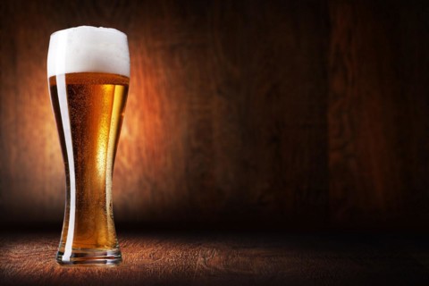 Glass beer on wood background with copyspace