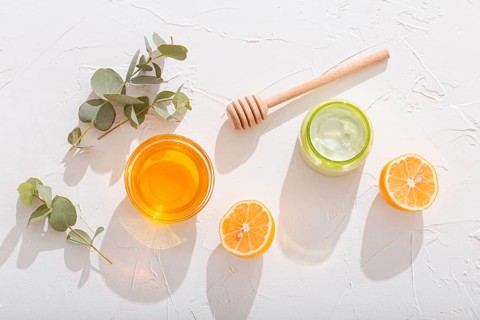 Natural organic ingredients for making cosmetic cream: avocado, honey, lemon and eucalyptus on