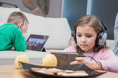 Kids using technologies living room