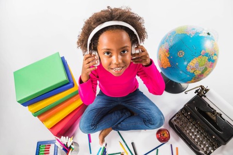 Girl headphones with study tools studio