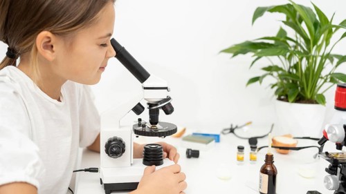 Girl looking into microscope