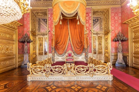 Turin, Italy - Circa August 2021: old throne room interior with chair in luxury palace. Red and