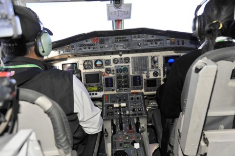 Cockpit of an aeroplane with pilot and numerous control elements, impressions of the great