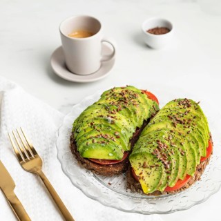 High angle avocado toast plate with cutlery coffee