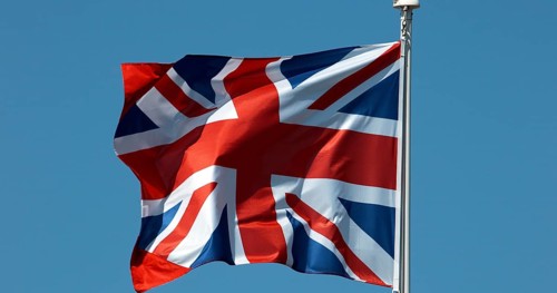 British Flag Waving in the Wind against blue sky