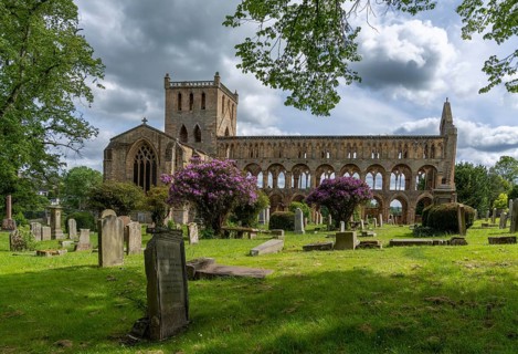 Jedburgh, United Kingdom - 18 June, 2022: view of the Augustinian Jedburgh Abbey ruins and cemetery