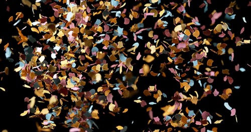Confettis Falling against Black Background