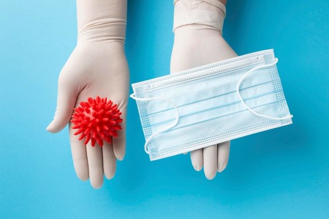 Top view hands holding virus medical mask