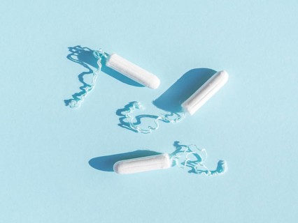 Menstrual tampons with thread blue background