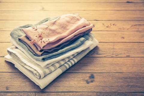 Concept of sustainability - fabric made from natural materials such as cotton and linen on wooden