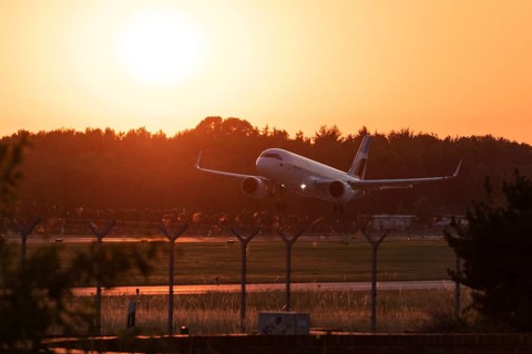 Passenger aircraft Airbus A320neo of the airline Eurowings in the evening glow during approach to