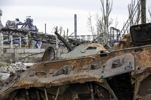 Burnt tank and destroyed buildings of the Azovstal plant shop in Mariupol war in Ukraine with