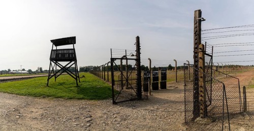 Auschwitz, Poland - 15 September, 2021: guard tower and prison camp gate at Auschwitz concentration