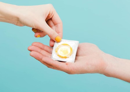 Woman giving condom another person