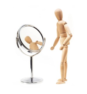 Narcissist wood mannekin looking at mirror over white