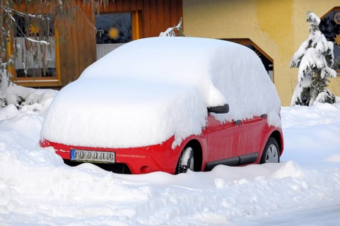 Snowed-in car at the house, car with snow