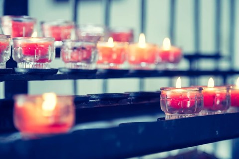 Close up of candles in old catholic church, blurry background