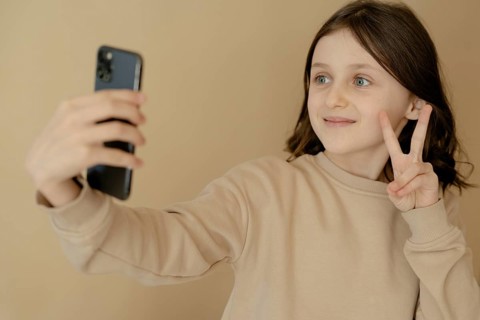 Girl, 10, takes a selfie with mobile phone
